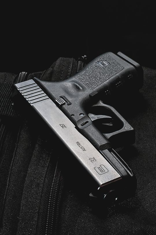 A pistol resting on a dark case